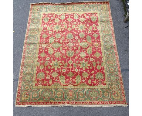 A cream and red ground Persian design carpet, with symmetrical pattern, 322cm x 254cm Carpet is in good overall condition, ju