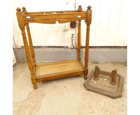 An early 20th century oak stick/umbrella stand, W60cm, H78cm, D30cm, and a cast-iron boot scraper (2) 