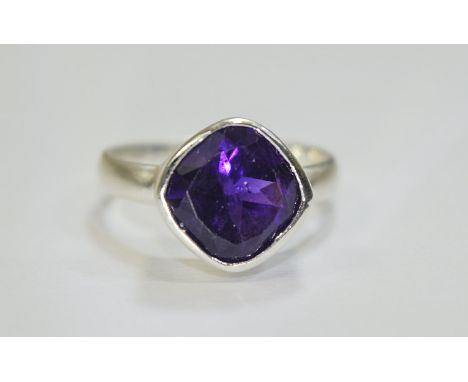 Amethyst Bezel Set Solitaire Ring, a 3.5ct, cushion cut, deep purple amethyst, bezel set in brushed silver; a contemporary, s