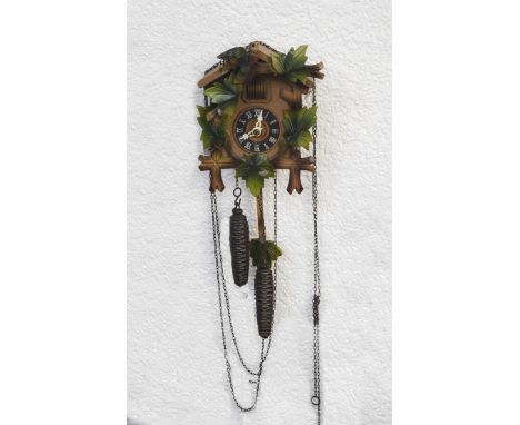 Small Wooden Cuckoo Clock Black Forest clock with traditional wooden foliage design and white dial. Boxed