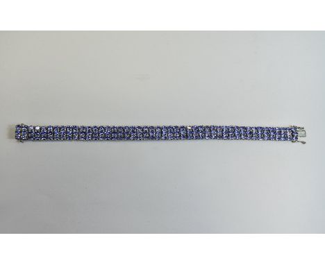 Tanzanite Three Row Bracelet, 27.5cts of oval cut tanzanites, of good colour,380 closely set in three rows in platinum vermei