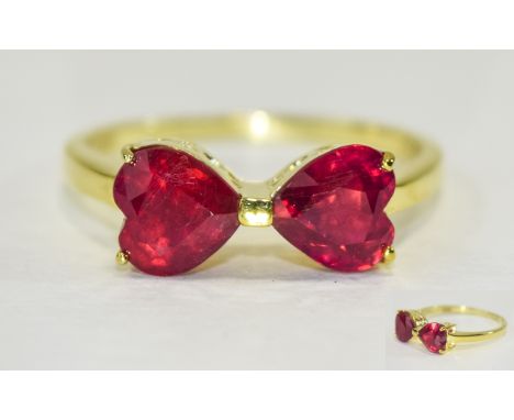 Ruby Double Heart Cut Ring, the two heart cut rubies, totalling 3.5cts, set point to point forming a bow, in 14ct gold vermei