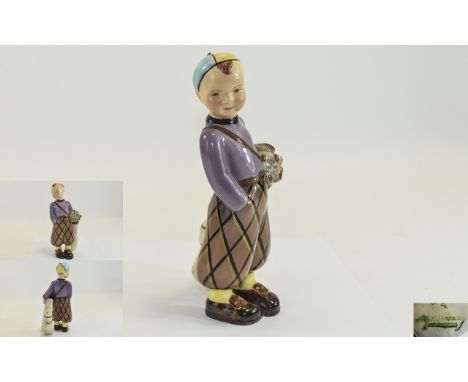 Goldscheider Boy Golfer Figurine. c.1920's, Fashioned as a Boy In Checkered Trousers, Lilac Jumper and Yellow and Blue Hat, Y