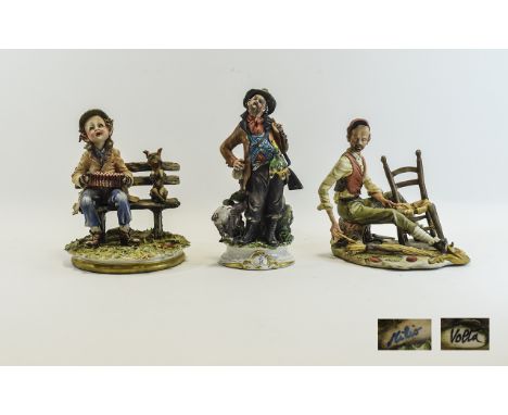 Three Capodimonte Figures One featuring a young boy and his dog on a bench playing the acordion, approx height 9 inches. Also