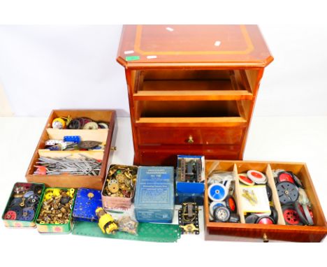 Meccano - A three drawer wooden cabinet containing a large quantity of Meccano parts. The wooden cabinet measures approximate