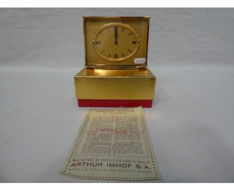 An Imhos Swiss made 15 jewel clock, Roman numerals to the dial #10804962 with outer box and guarantee.