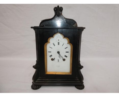 An early 19th century French ebonised mantel clock, white enamel dial with Roman numerals behind a shaped surround, hour and 