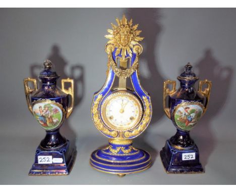 A Victoria &amp; Albert Museum clock entitled Marie Antoinette, cobalt blue ceramic with gilded highlights with branded logo 