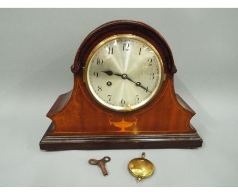 A mahogany cased mantel clock, Arabic numerals to a silvered dial, movement marked Wurttemberg with key and pendulum