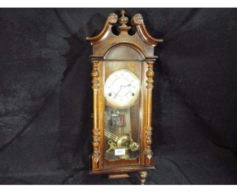 A 31 day wall clock, the white dial scribed President, Roman numerals, with pendulum and key, 59 cm (high)