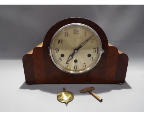 A mantel clock, Arabic numerals to the dial with key and pendulum