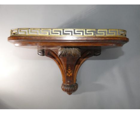 A decorative rosewood veneer wall bracket for clock or similar, inlaid stringing and floral motif, carved decoration and bras