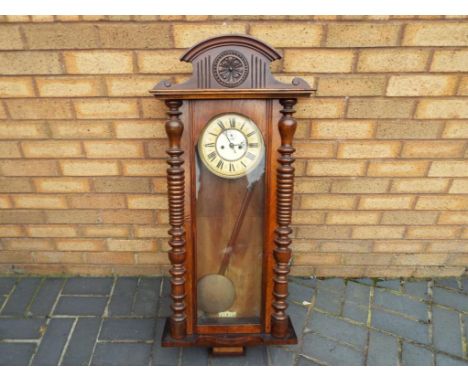 A Vienna style wall clock, walnut case with glazed opening door flanked by turned columns, two piece celluloid dial with Roma