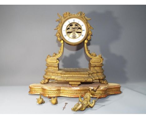 A spelter case French cherub pendulum mantel clock on a gilded wooden base, white enamel chapter ring, 32cm tall.Condition: c