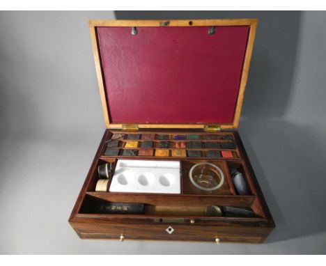 A 19th Century artist's box with inlaid decoration with fitted interior containing watercolour cakes, mixing tray and various