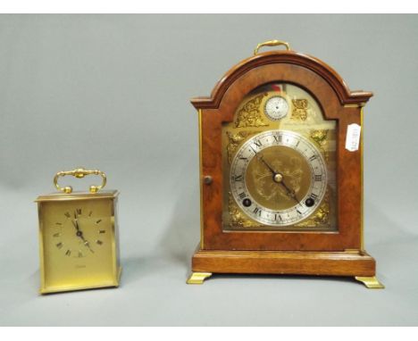 A mahogany cased mantel clock, Roman numerals on a silvered chapter ring with applied spandrels, chiming on the hour and half