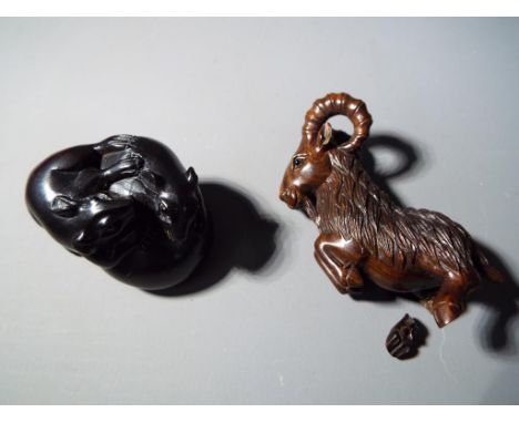 Netsuke - two vintage dark wood Japanese netsukes, one in a form of a running mountain sheep, the other depicting two rats/mi