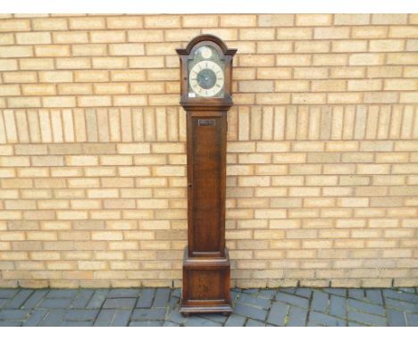 A Grandmother clock with Westminster chime with Tempus Fugit movement with pendulum and key