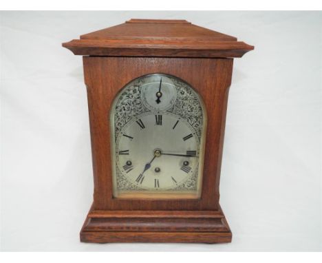  An early 20th century Westminster chiming mantel clock, arched silvered dial with decorative engraving, strike/ silent to th