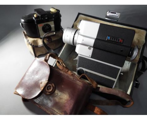 Photographic equipment - a mixed lot to include a Kodak Brownie 127 bakelite camera with dust cover, a Sankyo Super CN300 wit