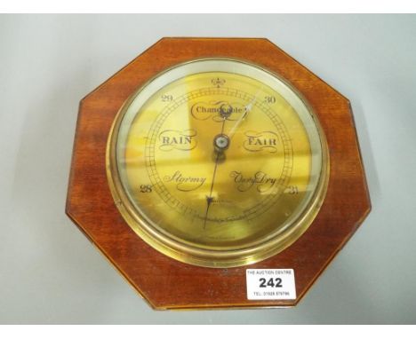 An aneroid barometer in octagonal shaped mahogany case, 23.5 cm (high)