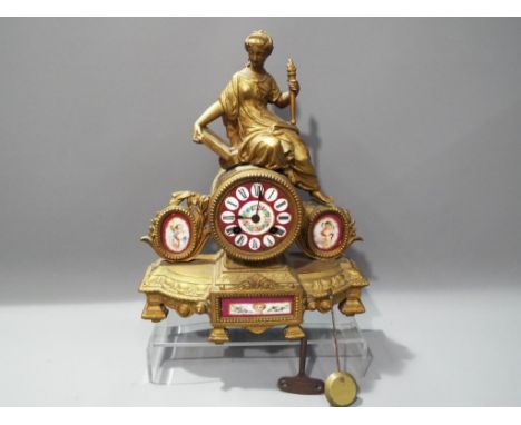 A French spelter cased figural mantel clock, dial and inset panels in floral maroon decoration, bell striking Japy Freres mov