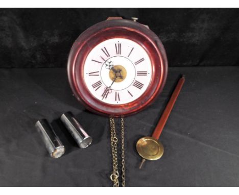 Postman's alarm clock - an early 20th century  weight driven wall mounted alarm clock with pendulum, Roman numerals on a pink