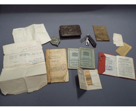 A military 1914 Christmas tin containing an Argyle and Sunderland cap badge, a Butler &amp; Co. pocket knife, identity card w