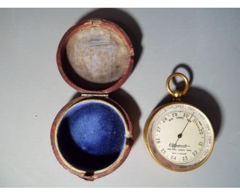 An E B Meyrowitz guild metal pocket barometer contained in fitted leather case approximately 4.5 cm diameter.
