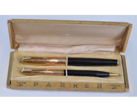A vintage Parker 51 Empire State special edition fountain pen and pencil set, in black with gold trim, the fountain pen barre