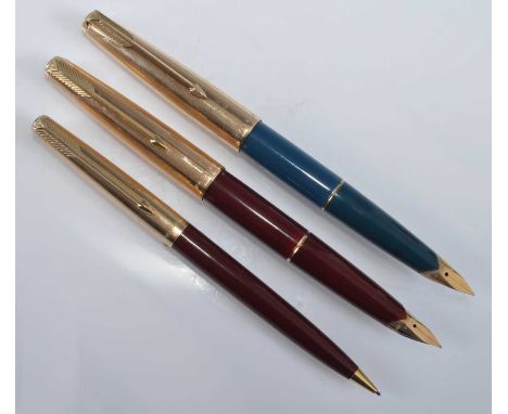Two Parker 65 double-jewelled fountain pens and a 65 pencil, the pens being in teal and burgundy, the pencil also in burgundy