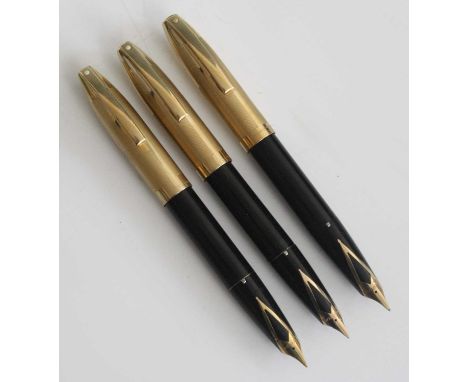 Three Sheaffer PFM V fountain pens, in black with gold trim, having rolled gold caps and 14k gold nibs, length 13.5cm (capped