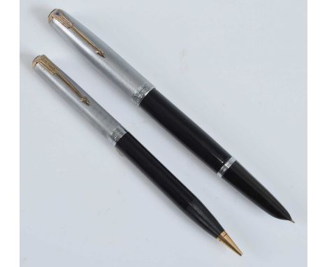 A Parker 51 fountain pen and pencil, in black with rolled silver trim, the fountain pen barrel inscribed PARKER "51" MADE IN 