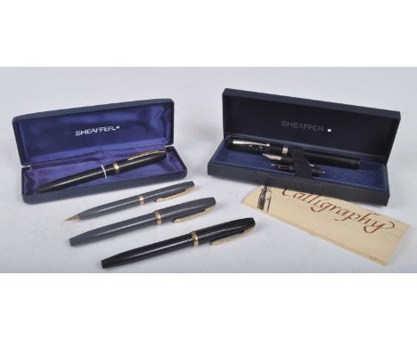 A cased Sheaffer Calligraphy fountain pen, in black with steel trim and scroll decorated cap, the ball-end tapering clip mark