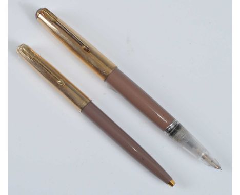 A Parker 51 half-demonstrator fountain pen and ballpoint pen, in Cocao with gold trim, the fountain pen barrel faintly inscri