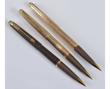 Three Parker 50 Falcon fountain pens, in Gold, Gold Signet, and Brown, the two gold examples engraved PARKER MADE IN ENGLAND 