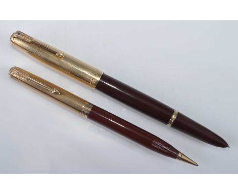A Parker 51 double-jewelled fountain pen and pencil, in Cordovan brown with filled gold caps, the blue diamond arrow clip Par