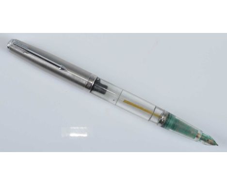 A Parker 51 Demonstrator fountain pen, with silver cap engraved PARKER arrow clip and jewel to top, the transparent barrel en