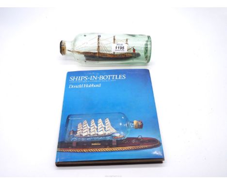 A vintage model of a ship in a bottle, titled Onyx, mid 20th century with a copy of 'Ships in Bottles', 9'' long.