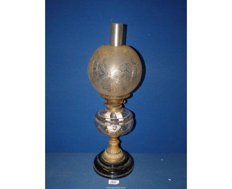 A Veritas base twin wick oil Lamp with brass detail, chimney and glass floral etched shade.
