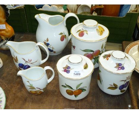 Six pieces of Royal Worcester 'Evesham' china including three storage jars, lemonade jug and two smaller graduated jugs.