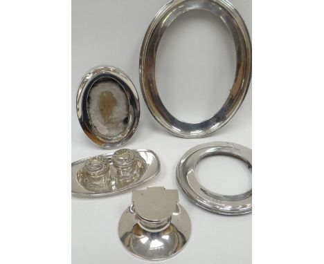 A parcel of silver items including three picture frames, a circular based inkwell, small dish etc