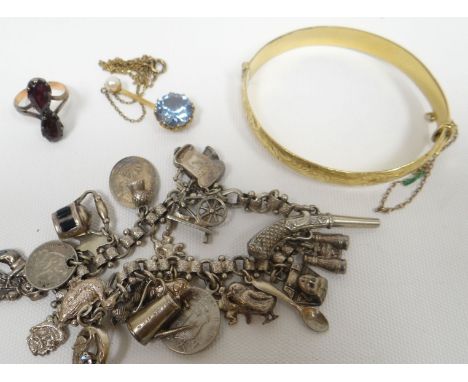 A 9ct gold metal cored bright-cut bangle; together with a 9ct yellow gold pendant set with large zircon and single pearl on a