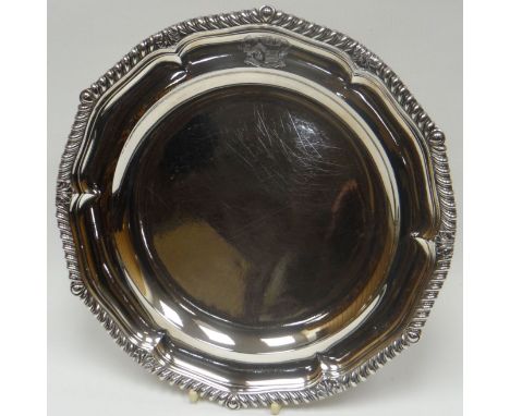 A George III silver shallow dish of shaped circular form, with gadrooned and acanthus border, engraved with crest, London 182