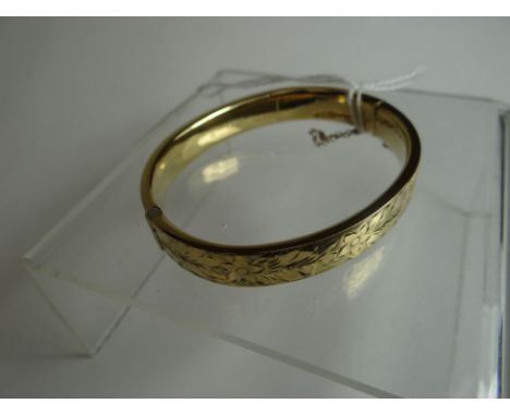 A 9ct yellow gold bright-cut clasp-bangle, 14.2gms