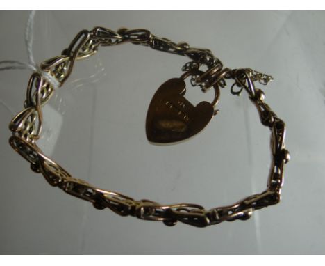 A 9ct yellow gold cross-over gate bracelet with heart-shaped pad-lock, 11.4gms