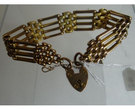 A 9ct yellow gold four-bar gate-bracelet with bright-cut heart-shaped padlock, 17gms