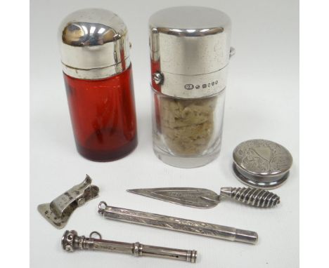 A parcel of small silver items comprising two silver topped glass scent bottles, a bright-cut silver pill-box, a silver 'trow