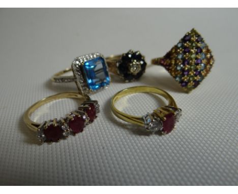 A parcel of four various 9ct yellow gold rings; together with an 18ct yellow gold ruby and diamond three stone ring, 16.8gms 