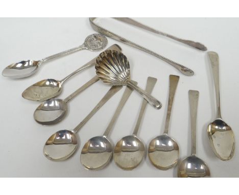 A parcel of silver flatware including George II sugar tongs, London by George Burrows, 1oz; together with a Georgian scallop-